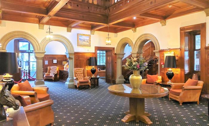 Open lounge with minstrels gallery. Reception doors lead on to the patio and terrace